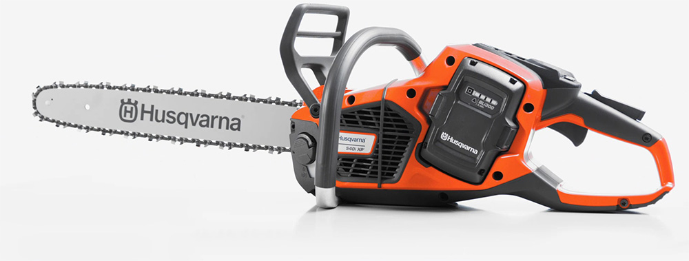 Eine orange-graue Husqvarna-Kettensäge vor weißem Hintergrund.